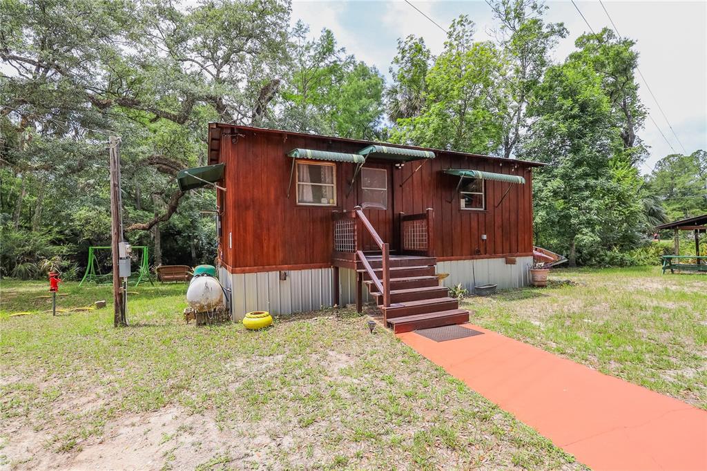 3850 Southeast 22 Court Bronson, FL 32621 - Photo 5 of 40 a backyard of a house with barbeque oven