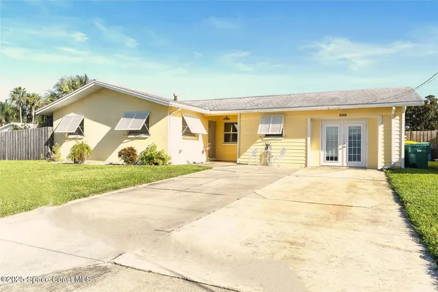 a living room with fireplace furniture and a potted plant