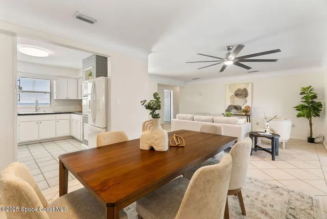 a bed room with a bed and a ceiling fan