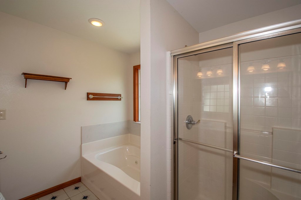 5224 Laurel Ridge Young Harris, GA 30582 - Photo 19 of 39 a bathroom with a bathtub and a shower