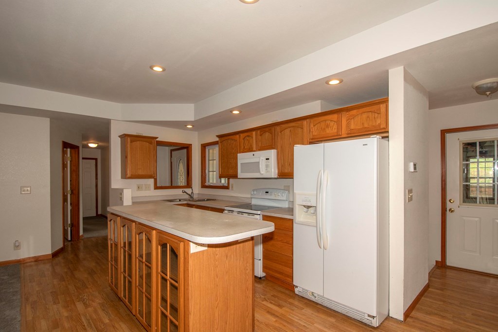 5224 Laurel Ridge Young Harris, GA 30582 - Photo 10 of 39 a kitchen with stainless steel appliances granite countertop a refrigerator a sink and a stove with wooden floors
