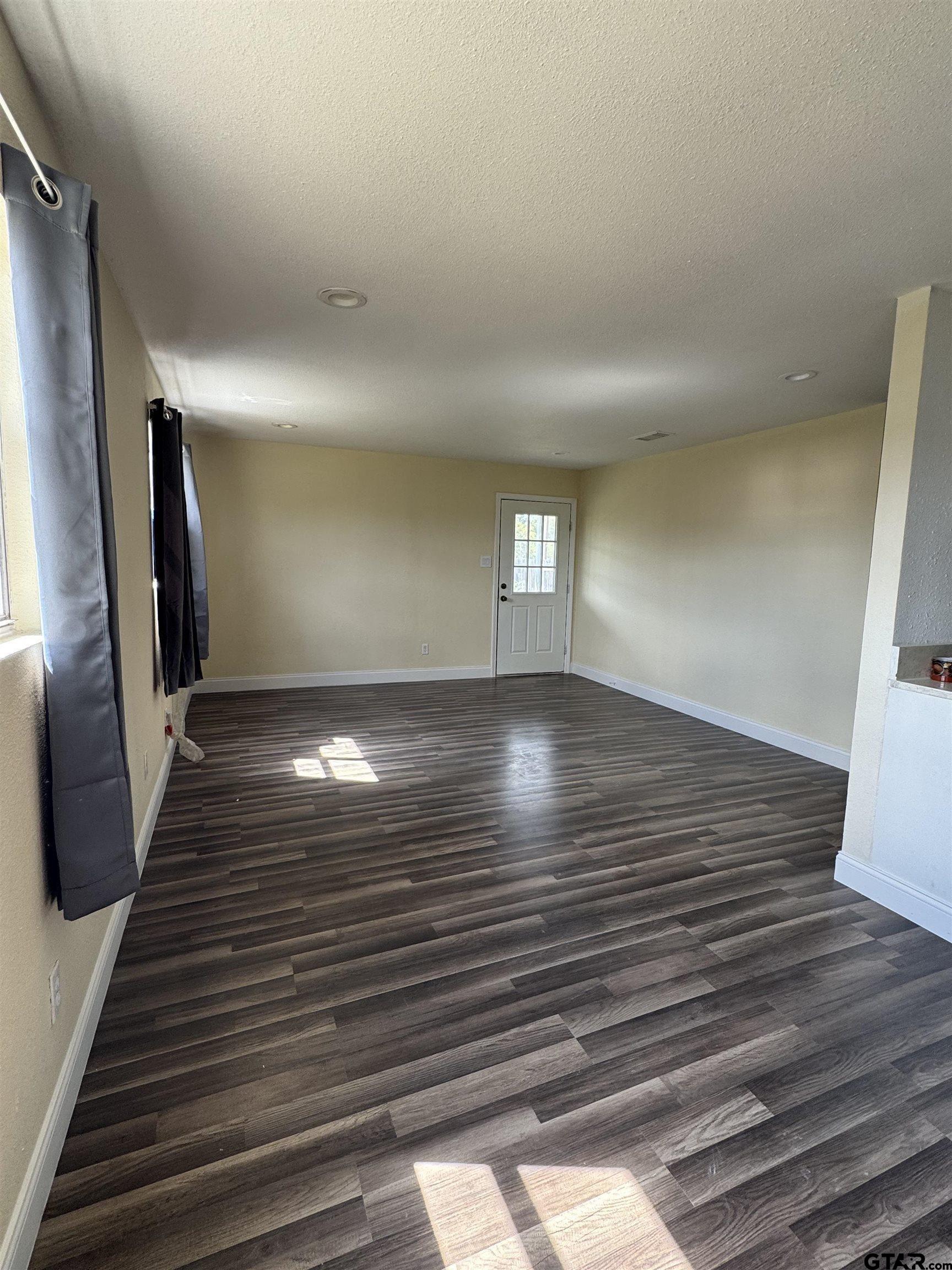 16238 Esther Road Lindale, TX 75771 - Photo 5 of 7 a view of room with window and wooden floor
