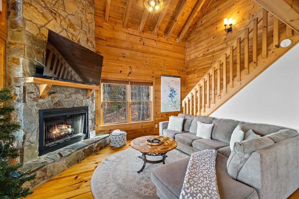 907 Ripshin Mountain Road Blue Ridge, GA 30513 - Photo 19 of 55 a living room with furniture a rug and a fireplace