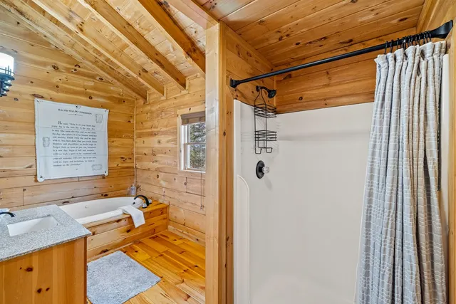 a view of a patio with table and chairs with wooden floor and fence