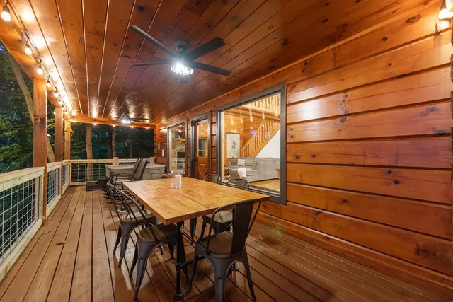 a roof deck with couch and chairs