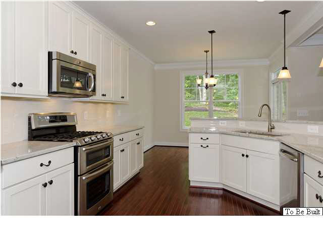 12 Timber Ridge Court Gordonsville, VA 22942 - Photo 14 of 31 a kitchen with stainless steel appliances granite countertop a sink a microwave a stove and white cabinets