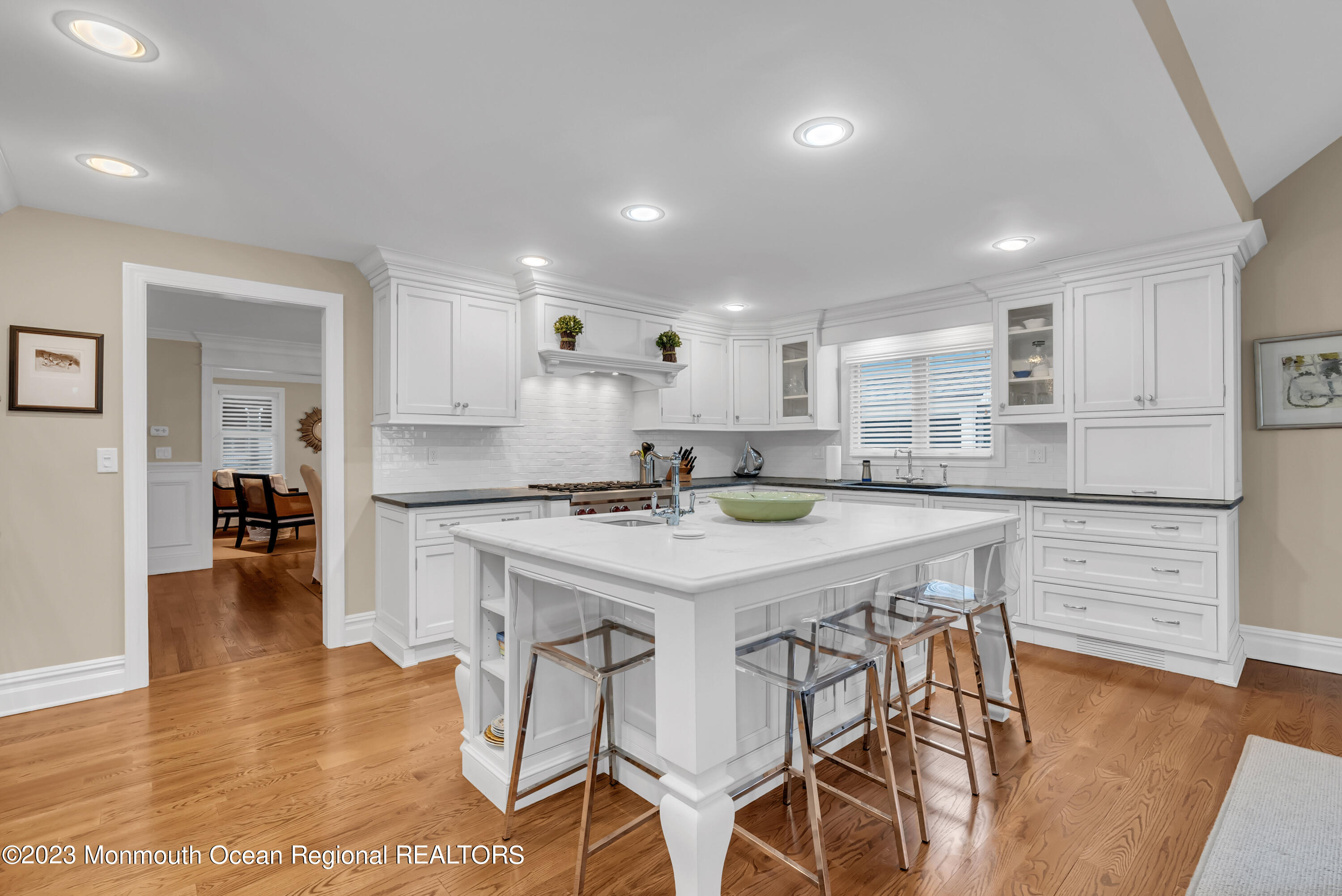 306 Worthington Avenue Spring Lake, NJ 07762 - Photo 17 of 52 a kitchen with stainless steel appliances kitchen island granite countertop a stove a sink a dining table and chairs