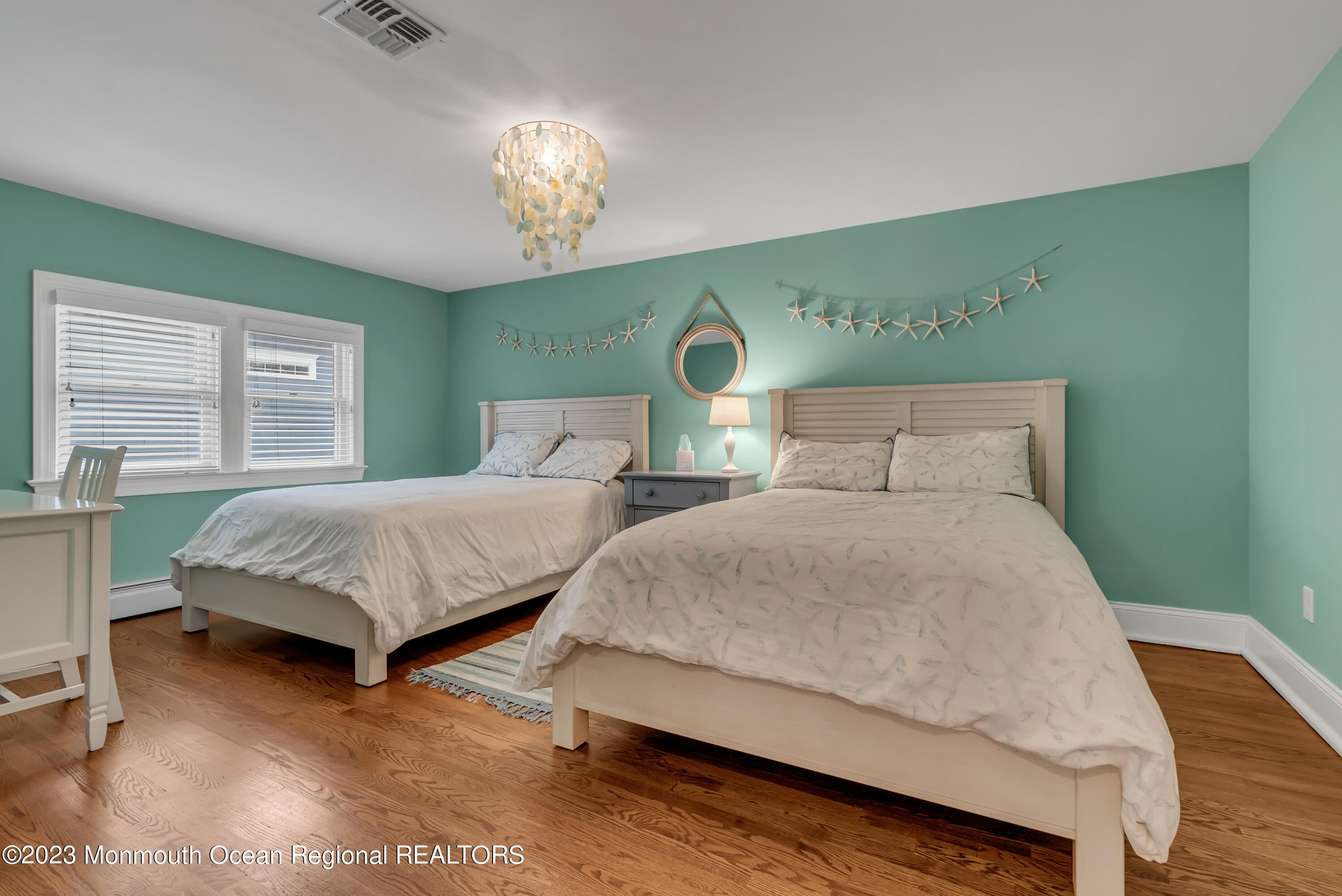 306 Worthington Avenue Spring Lake, NJ 07762 - Photo 28 of 52 a bedroom with double bed and a chandelier