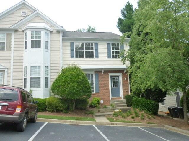 9155 Nesbit Ferry Road, Unit 110 Alpharetta, GA 30022 - Photo 1 of 1 a front view of a house with a garden