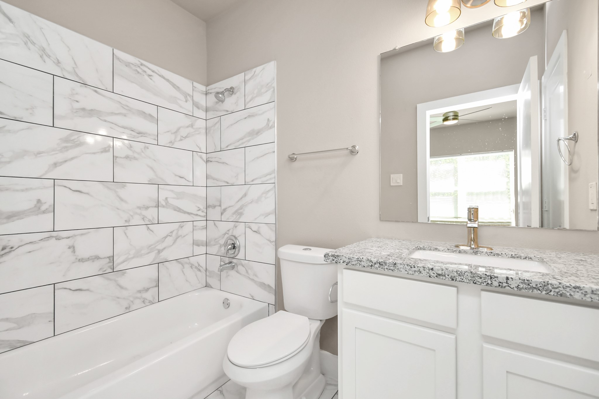 3538 Noah Street Houston, TX 77021 - Photo 5 of 33 a bathroom with a granite countertop toilet sink and mirror