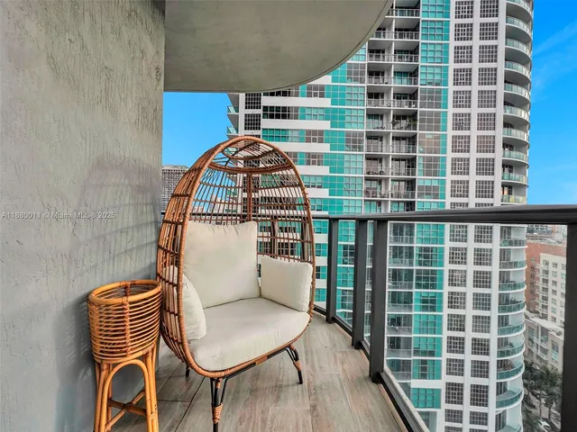 a view of a balcony with wooden floor and breakfast area