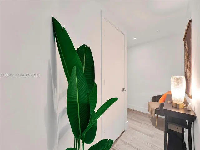 a view of a balcony with wooden floor and potted plants