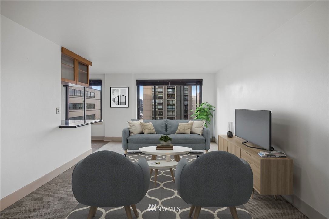 1105 Spring Street, Unit 1006 Seattle, WA 98104 - Photo 4 of 22 a living room with furniture and a flat screen tv