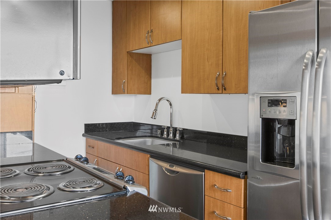 1105 Spring Street, Unit 1006 Seattle, WA 98104 - Photo 9 of 22 a kitchen with a sink and a stove