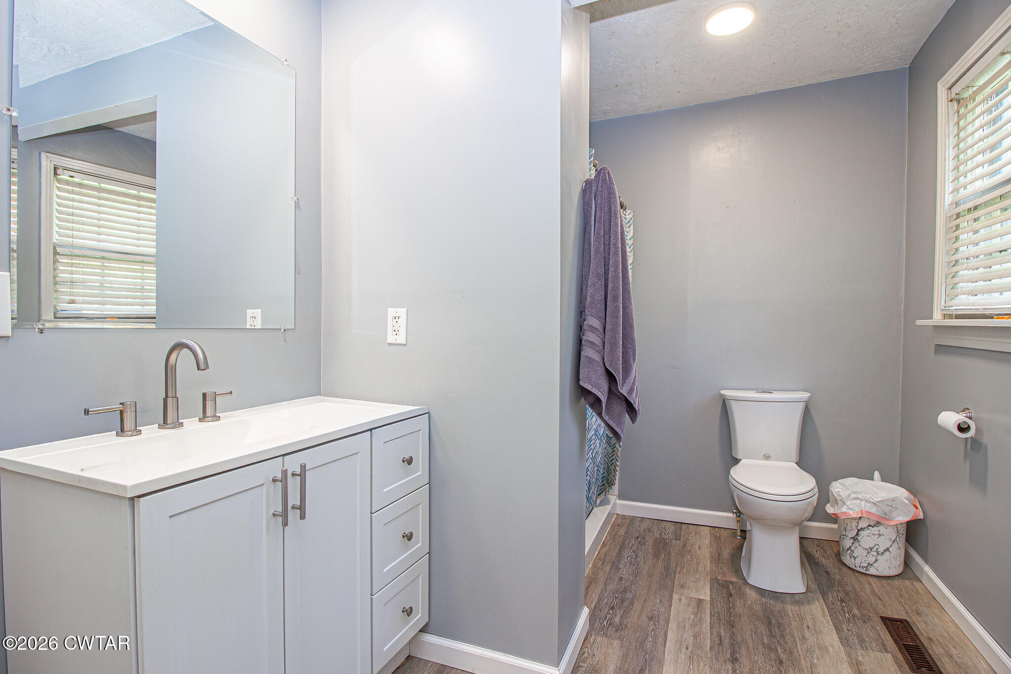 3075 Arnold Street Milan, TN 38358 - Photo 13 of 24 a bathroom with a sink toilet vanity and window
