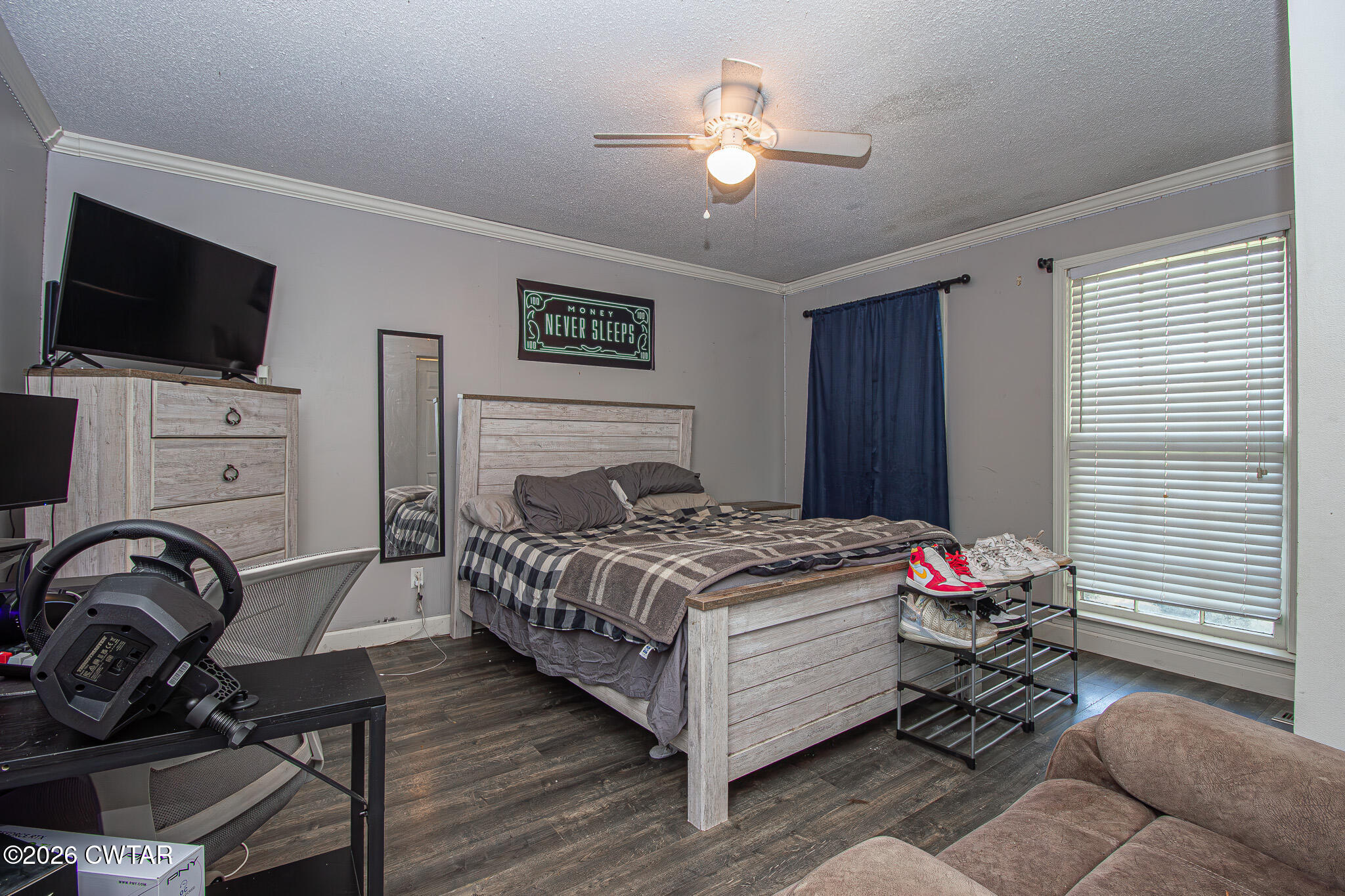 3075 Arnold Street Milan, TN 38358 - Photo 14 of 24 a bedroom with a bed and a flat screen tv