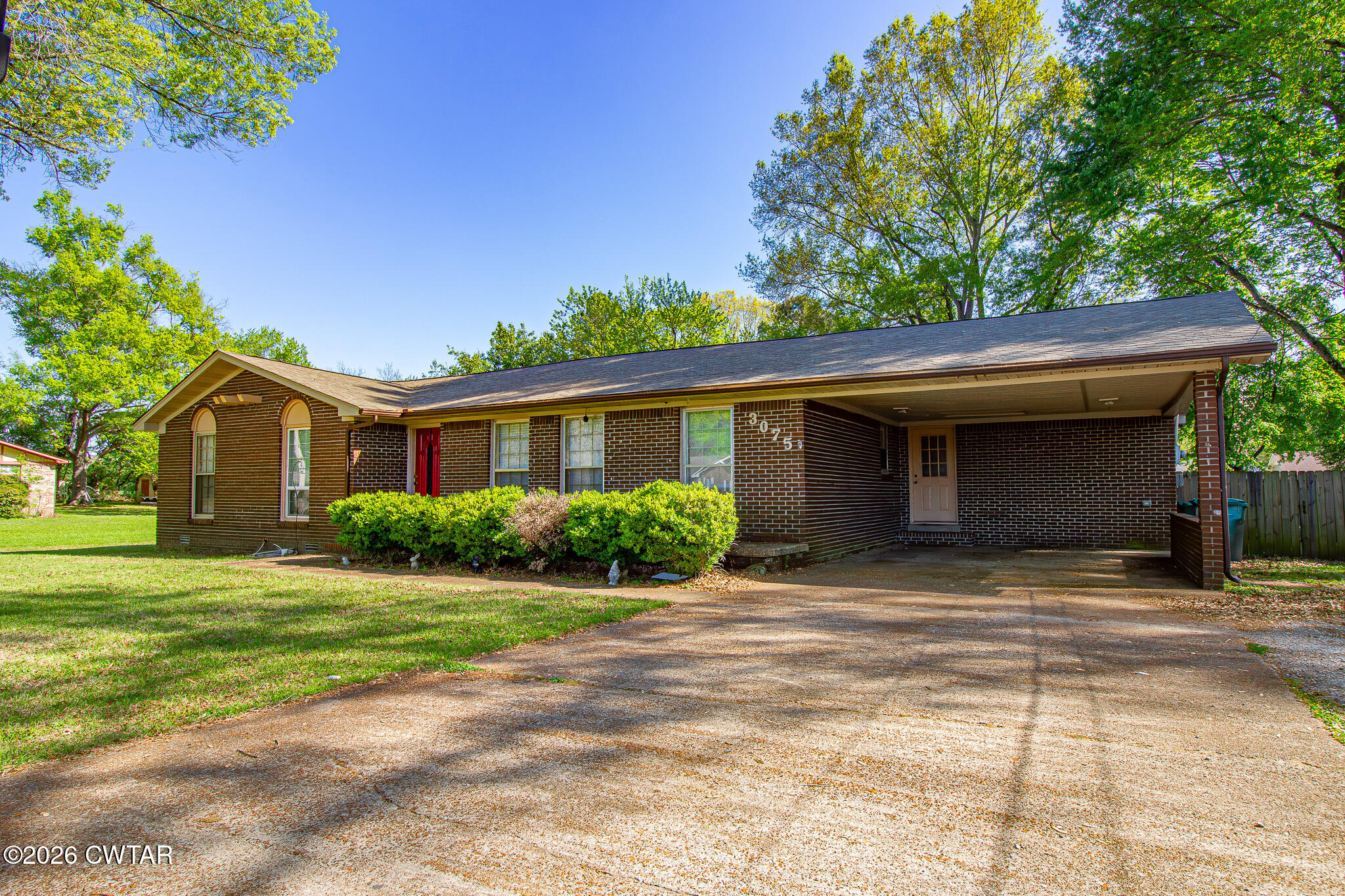 3075 Arnold Street Milan, TN 38358 - Photo 2 of 24 a front view of a house with a yard and garage