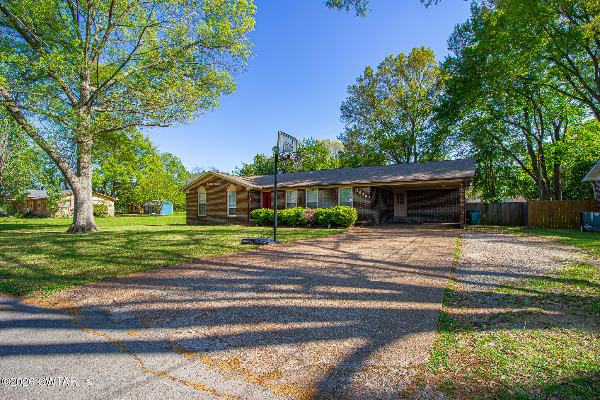 3075 Arnold Street Milan, TN 38358 - Photo 3 of 24 a front view of a house with a yard