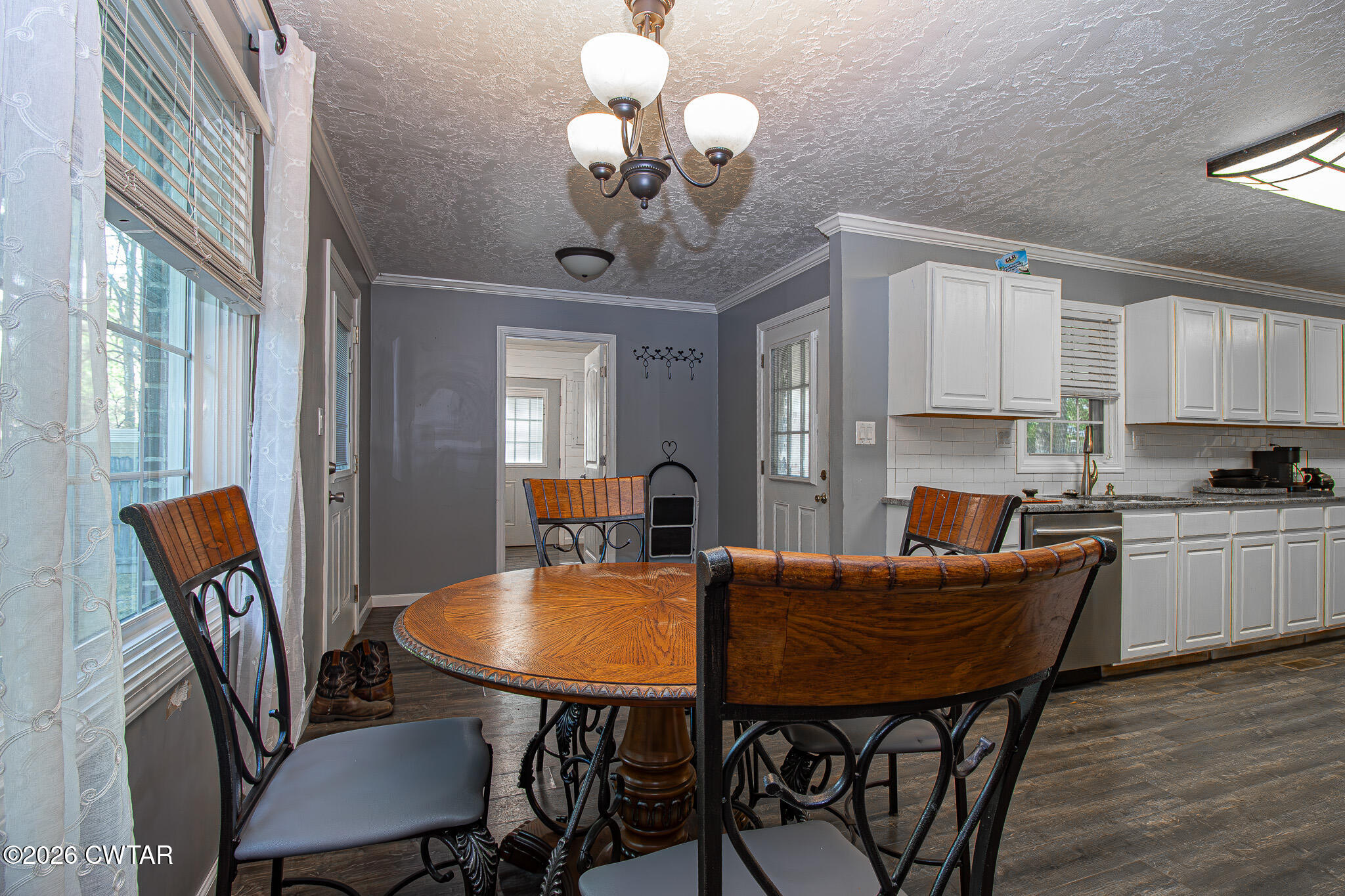 3075 Arnold Street Milan, TN 38358 - Photo 7 of 24 a view of a dining room with furniture and wooden floor