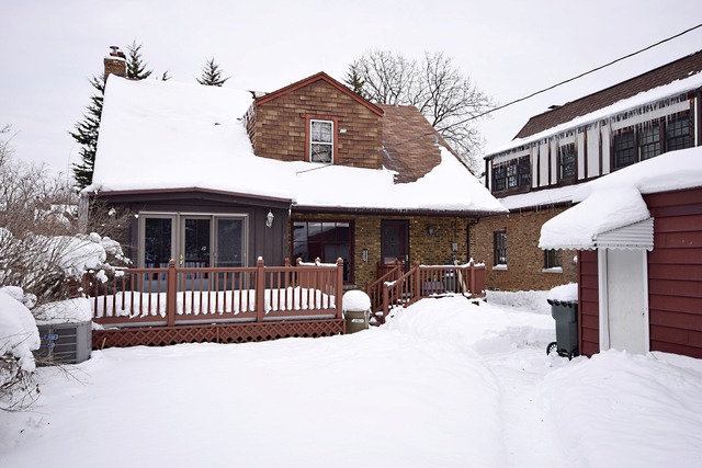 489 Uvedale Road Riverside, IL 60546 - Photo 19 of 25 a view of a house with a wooden fence