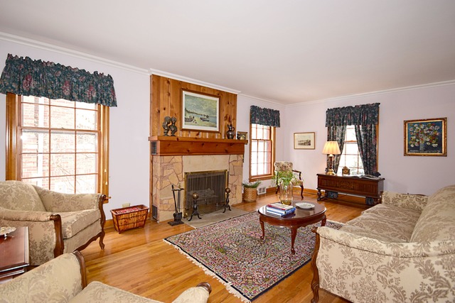 489 Uvedale Road Riverside, IL 60546 - Photo 3 of 25 a living room with furniture a fireplace and a large window