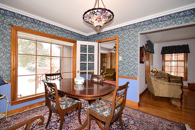 489 Uvedale Road Riverside, IL 60546 - Photo 5 of 25 a dining room with furniture a chandelier and wooden floor