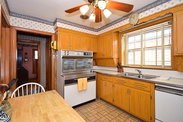 489 Uvedale Road Riverside, IL 60546 - Photo 7 of 25 a kitchen with stainless steel appliances granite countertop a sink a stove cabinets and dining table