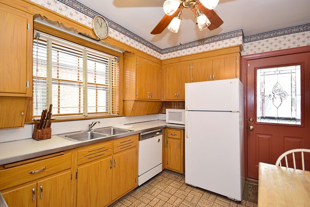 489 Uvedale Road Riverside, IL 60546 - Photo 8 of 25 a kitchen with a sink and a refrigerator