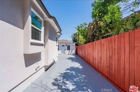 a view of a balcony with wooden floor and stairs