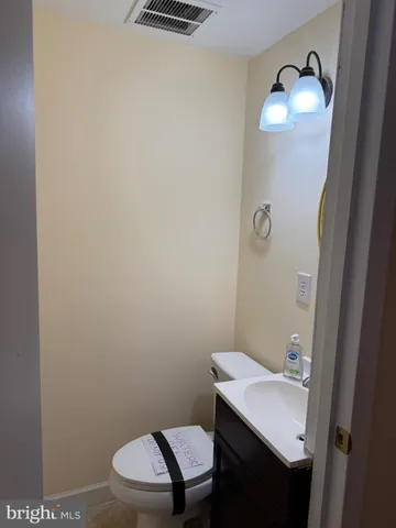 a bathroom with a toilet a sink and vanity