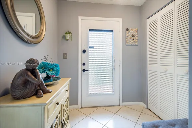 a room with a stove and a potted plant