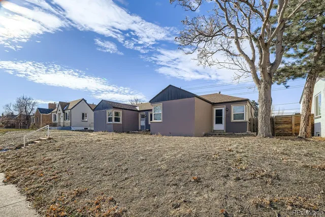 a house that has a tree in front of it
