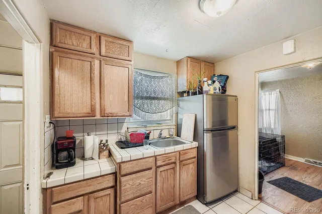 a kitchen with a refrigerator and a sink