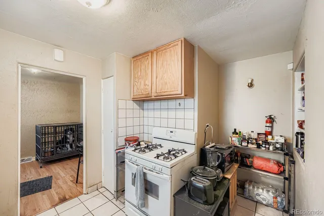 a kitchen with a stove and a refrigerator