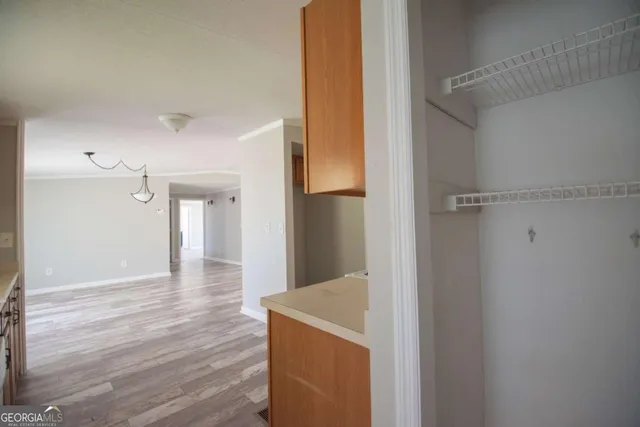 a view of a hallway with wooden floor