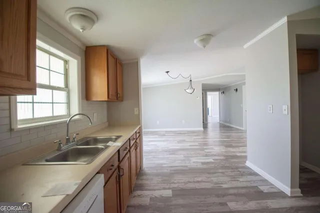 a kitchen with a sink stove and cabinets