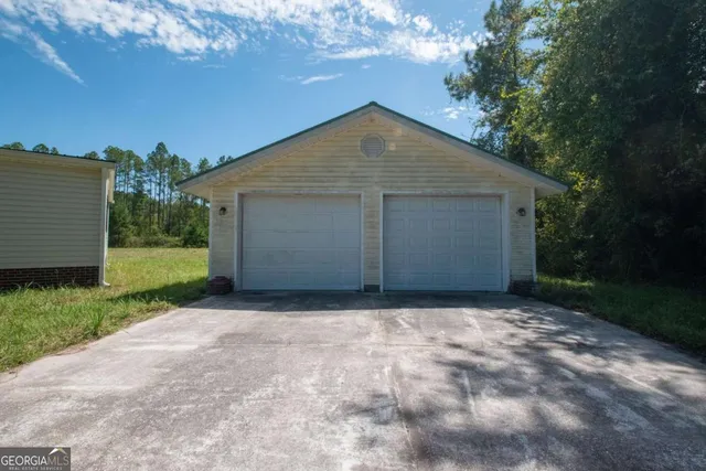 a front view of a house with a garden and deck