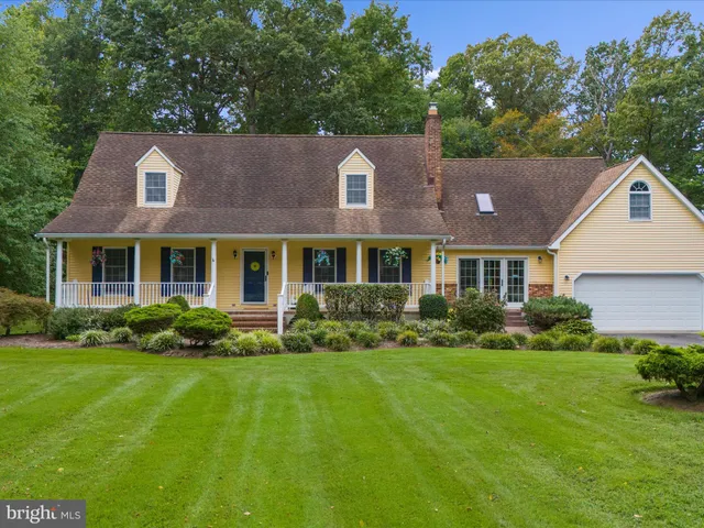 a view of a bedroom with furniture and wooden floor