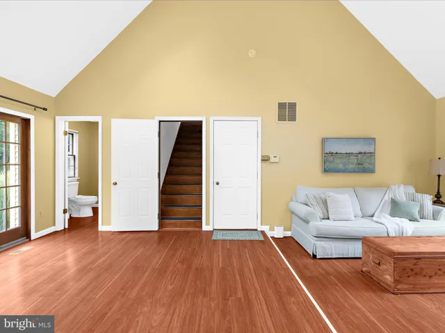 a view of a livingroom with an empty space and wooden floor