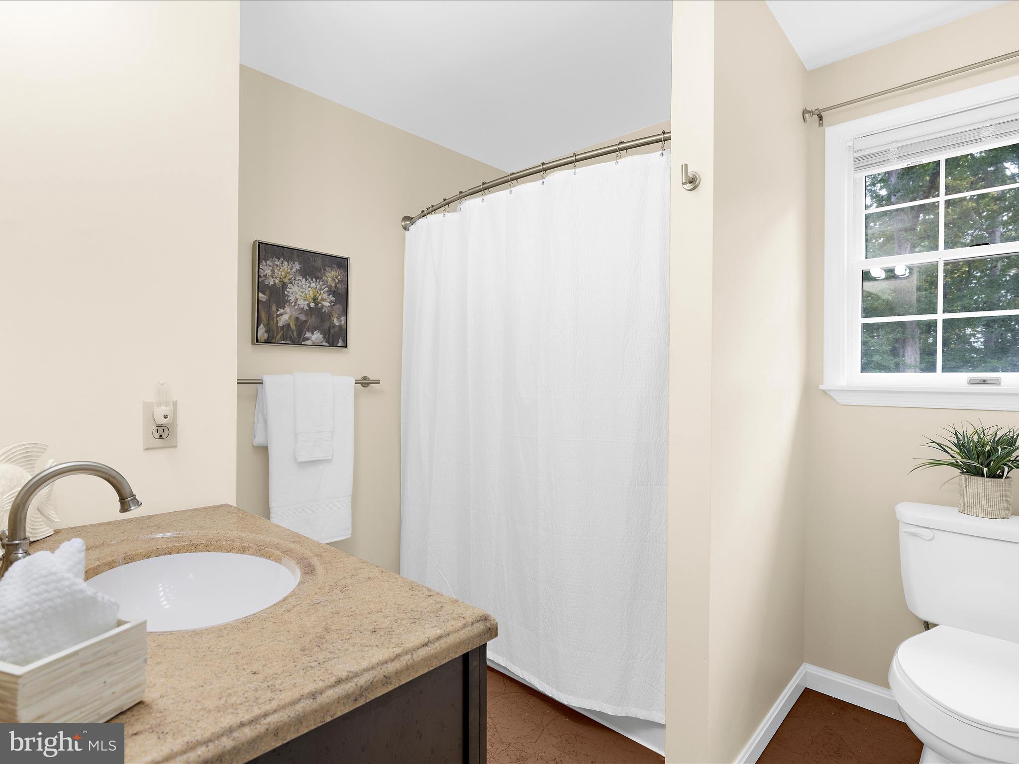 100 Marlborough Road Queenstown, MD 21658 - Photo 54 of 83 a bathroom with a granite countertop sink and a mirror