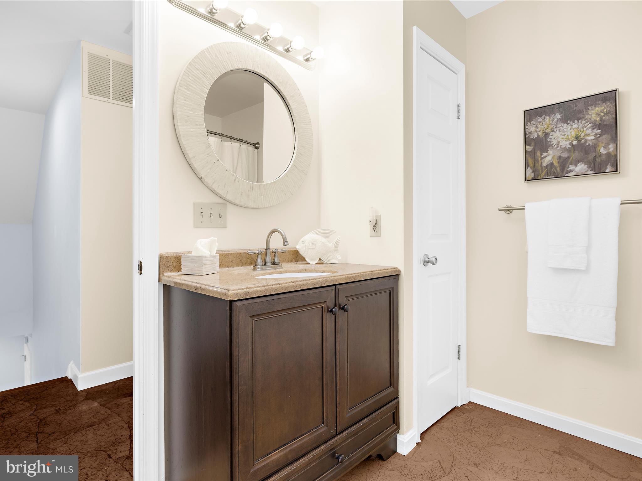 100 Marlborough Road Queenstown, MD 21658 - Photo 56 of 83 a bathroom with a sink vanity and a mirror
