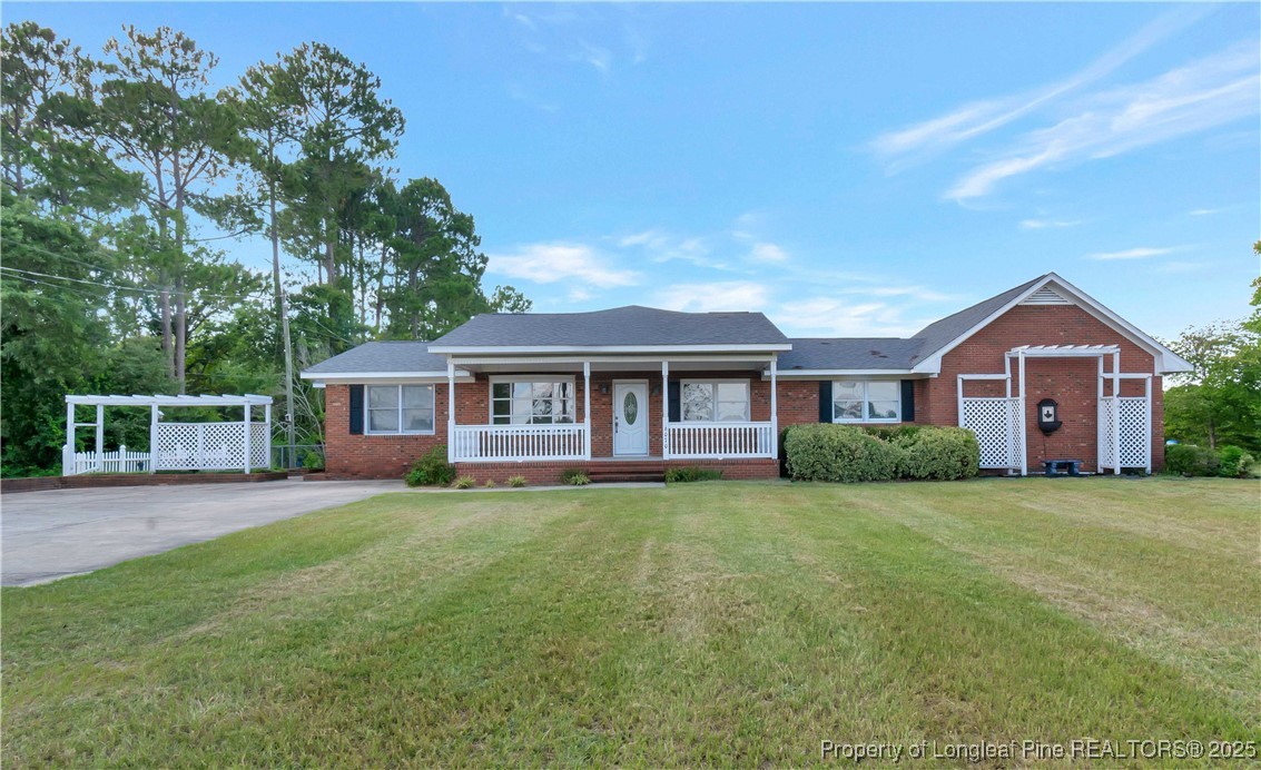 6036-6070 Camden Road Fayetteville, NC 28306 - Photo 2 of 45 a front view of a house with a garden