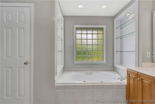 an empty room with a window and ceiling fan