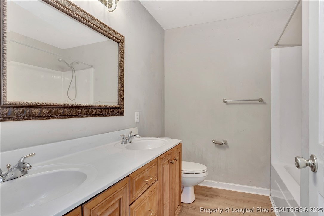 6036-6070 Camden Road Fayetteville, NC 28306 - Photo 31 of 45 a bathroom with a granite countertop sink toilet and shower