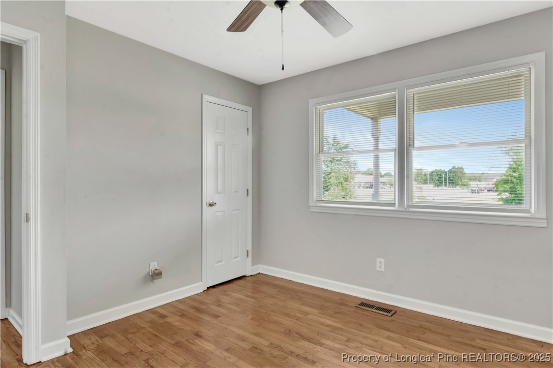 6036-6070 Camden Road Fayetteville, NC 28306 - Photo 33 of 45 a view of an empty room with a window and wooden floor
