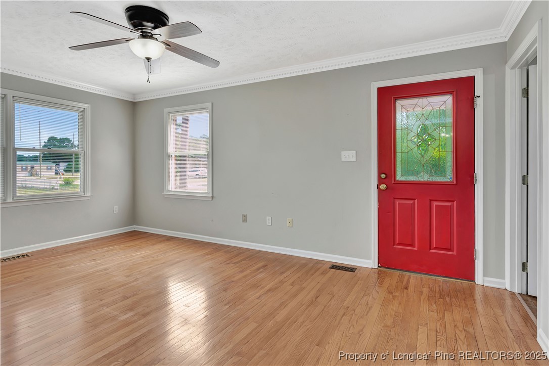 6036-6070 Camden Road Fayetteville, NC 28306 - Photo 35 of 45 a view of an empty room with window and wooden floor