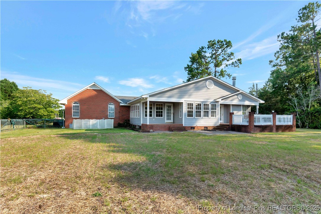 6036-6070 Camden Road Fayetteville, NC 28306 - Photo 39 of 45 a front view of a house with a garden and trees