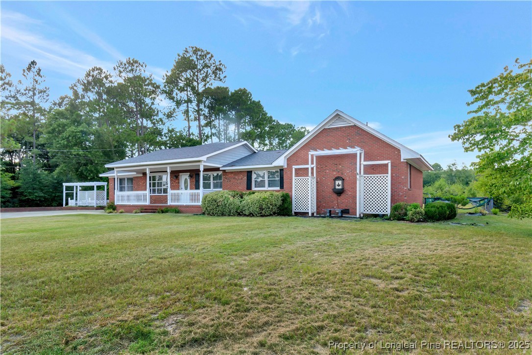 6036-6070 Camden Road Fayetteville, NC 28306 - Photo 4 of 45 a front of a house with a garden