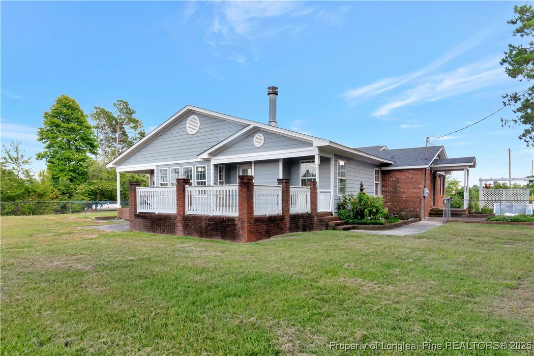 6036-6070 Camden Road Fayetteville, NC 28306 - Photo 41 of 45 a front view of a house with a yard porch and outdoor seating