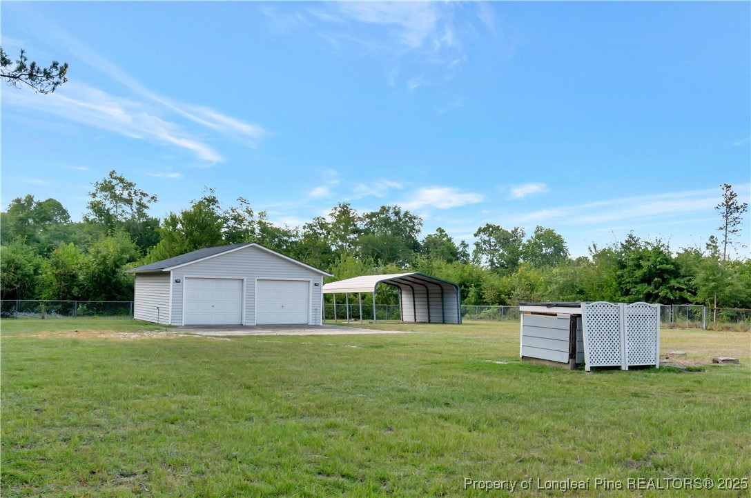 6036-6070 Camden Road Fayetteville, NC 28306 - Photo 42 of 45 a house with green field in front of it